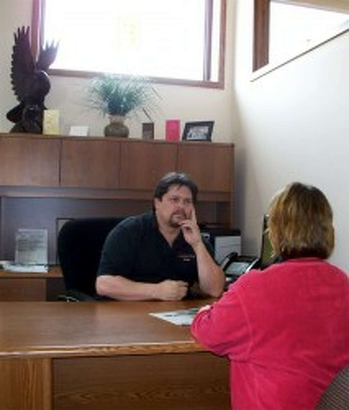 LAKE AND LODGE: Realtor Randy Ostrander listens to a client’s questions at his downtown Big Rapids office. Ostrander earned his Realtor’s license in 2008. (Courtesy photo)