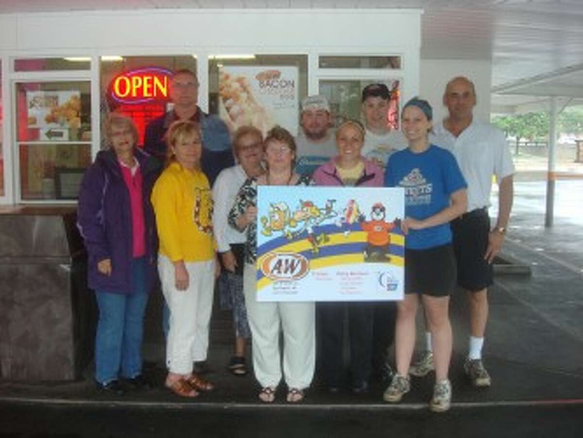 DEFENDING CHAMPIONS: The team from A&W Drive-in won the 15-hour Distance Relay Race, which was a mini-game held within last year’s Relay for Life of Mecosta County. A similar event is being held at this year’s relay, which is scheduled for Sept. 15 at Hemlock Park. Pictured (in no particular order) are A&W owner, Mike Page; employees, Jeremy Griffis, Brian Maneke, Emily Schriner and Kim Peterson; and Ferris State University United Team members Barb Gilmore, Quentin Kramer, Brenda Griffis, Janel DePew and Karen Ottobre. (Pioneer photo/Jonathan Eppley)