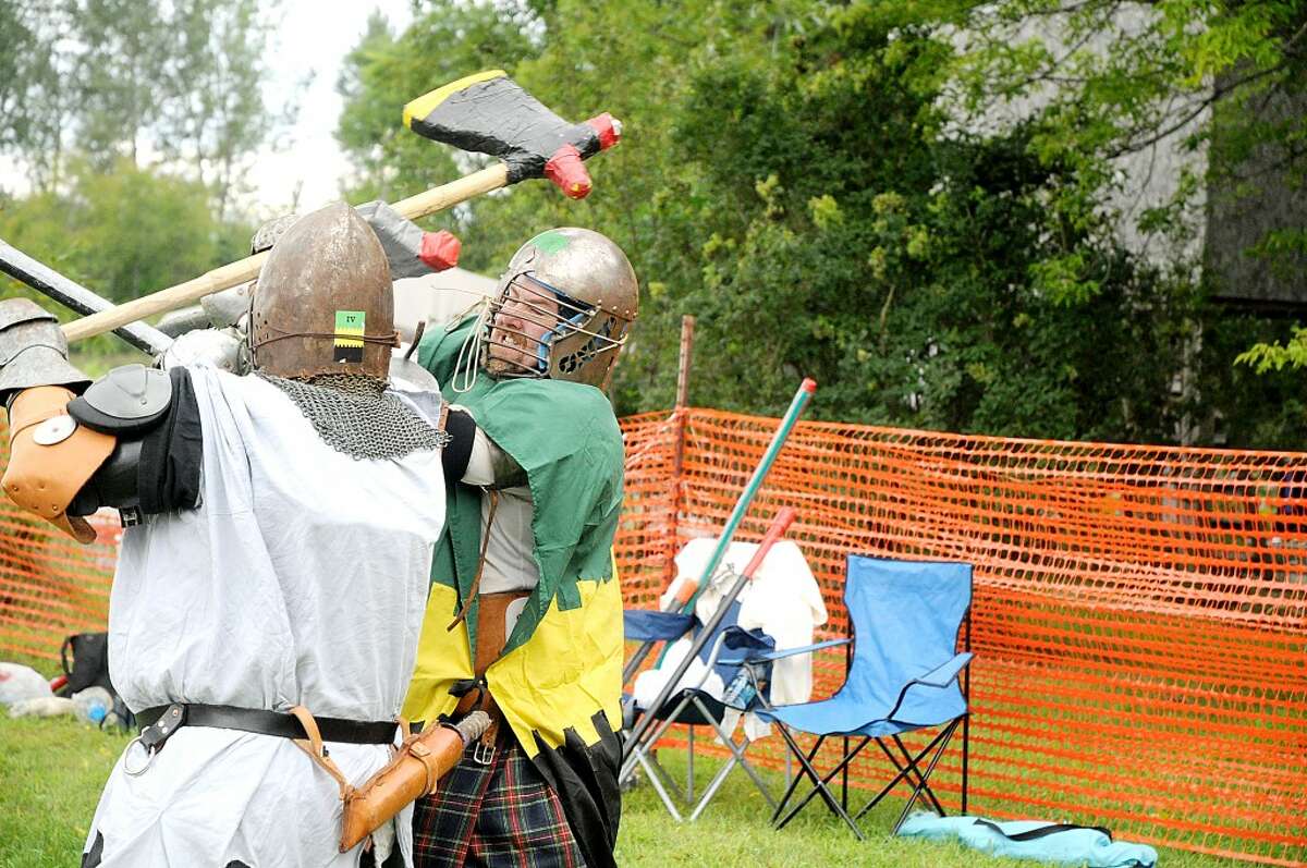 BATTLE: Two men battle in heavy combat, a simulated medieval combat sport, at the seventh annual Wolf Run Harvest Festival and Psychic Fair on Saturday. (Pioneer photo/Kyle Leppek)