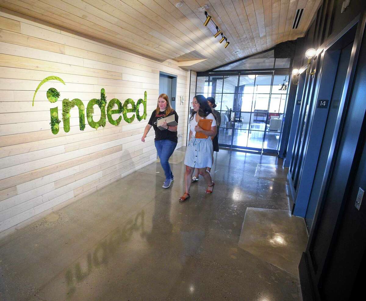 Indeed employees stroll between work areas in the firm’s offices at 177 Broad St., in downtown Stamford, Conn., on July 24, 2019.