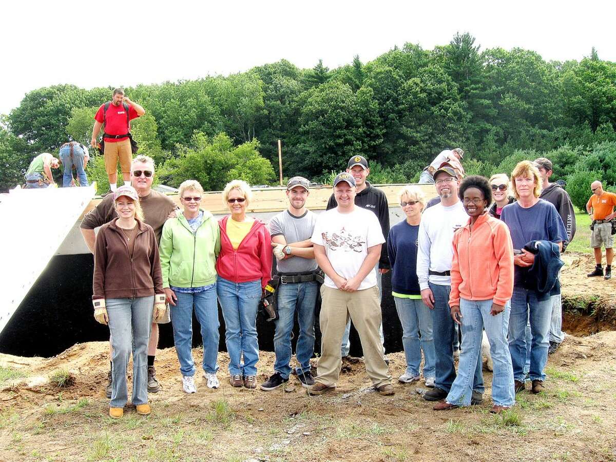 HELPING OUT: Members of the Resurrection Life Church of Big Rapids joined Mecosta County Habitat for Humanity volunteers on Aug. 11 to begin construction on the affiliate's 29th home, located near Morley. (Courtesy photo)