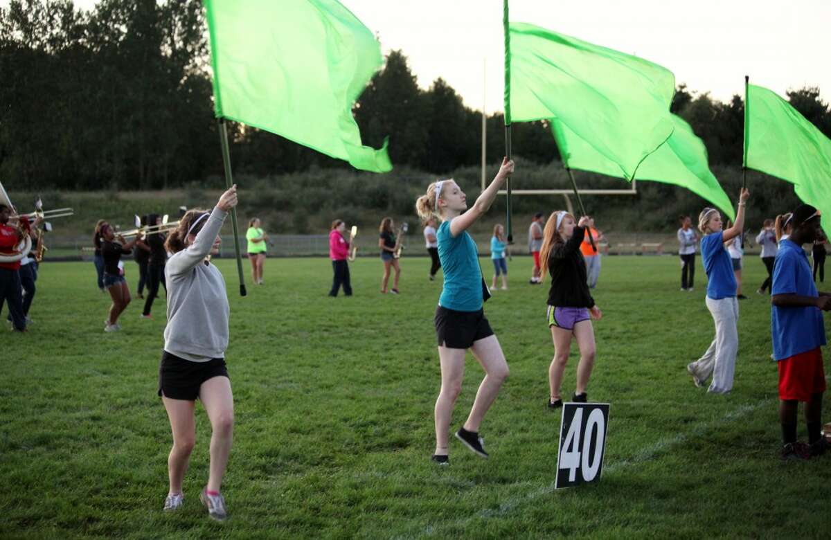 FLYING COLORS: The color guard practices its moves during marching band rehearsal on Monday. Big Rapids High School’s marching band will perform for the first time this year on Friday.