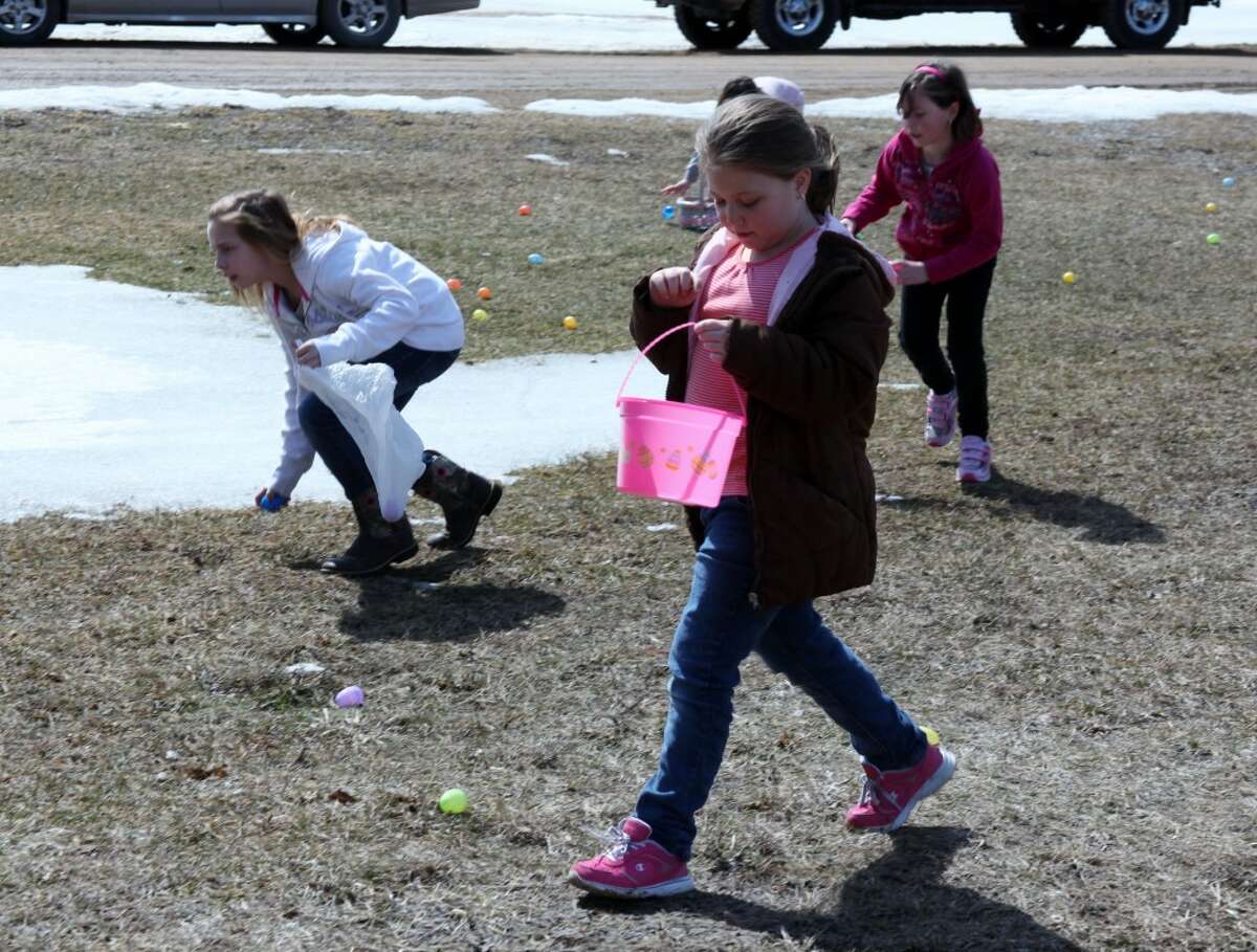 Children spread out across the yard at the Mecosta County Youth and Family Center in Mecosta to collect Easter eggs. More than 100 people turned out for Saturday's event.