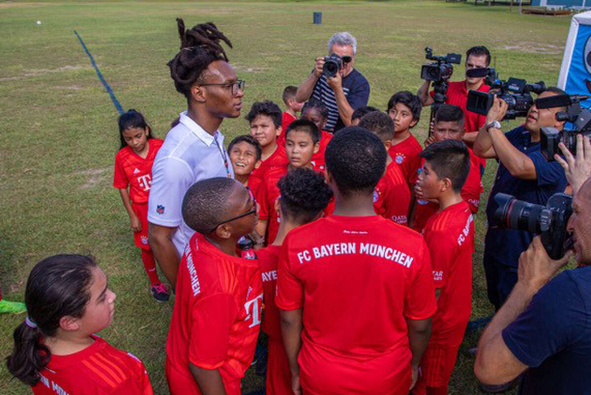 Texans receiver DeAndre Hopkins, visiting with players in the Freekicks Soccer program, grew up playing the sport before having to forego club soccer for financial reasons.