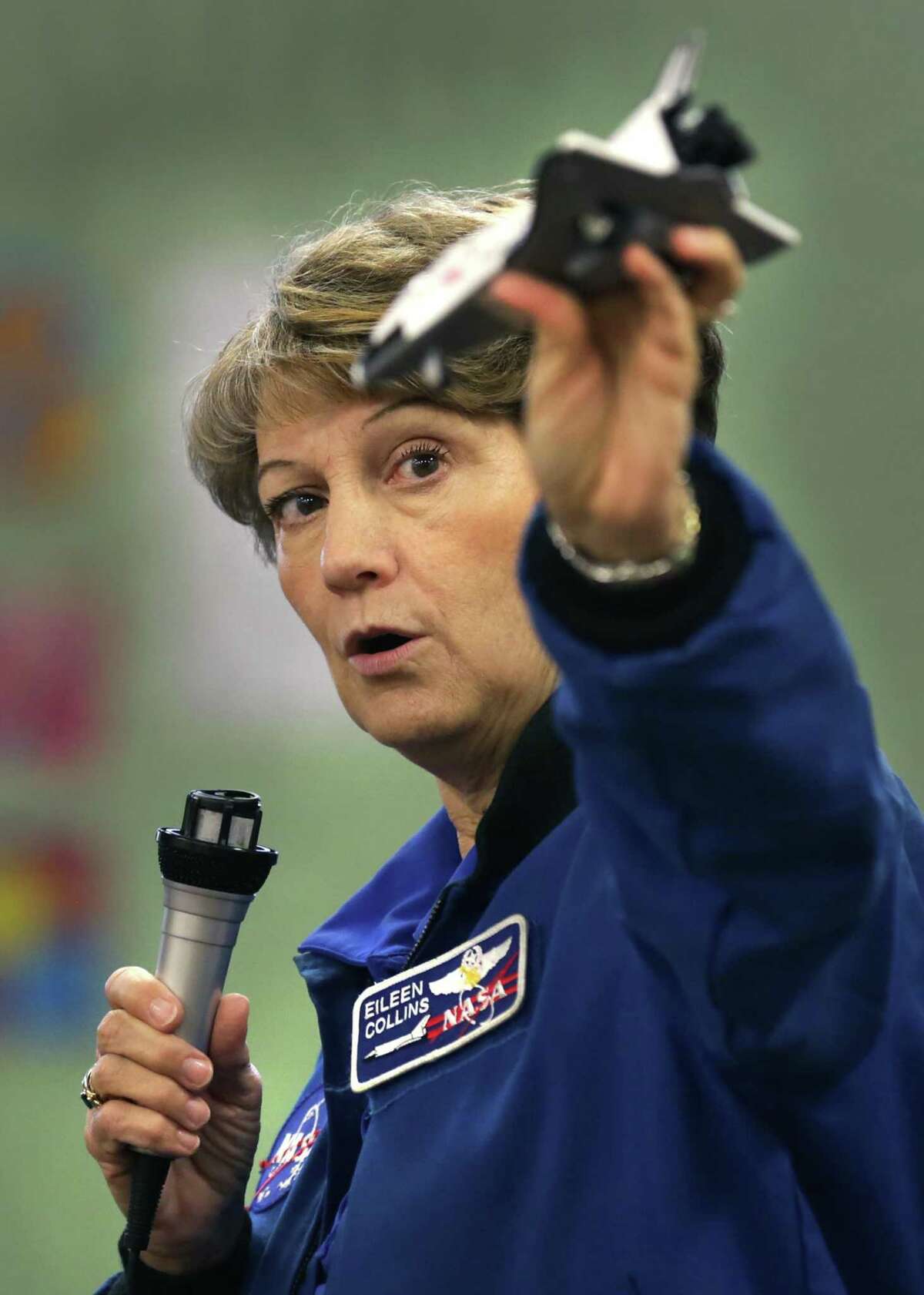 Col. Eileen Collins, NASA's first female Shuttle Commander, demonstrates with a model the flight of the Space Shuttle as she visits girls in the Space Odyssey session of Camp Metro, held by West Side Girl Scout Leadership Center on Thursday, July 25, 2019.