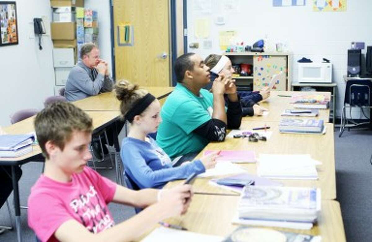 OBSERVATIONS: CCA middle/high school principal Ross Meads sits in the back of classroom observing a teacher. Principals are required to complete one formal evaluation of all teachers each school year, and many also gather information through a series of informal "walk throughs" of each classroom.