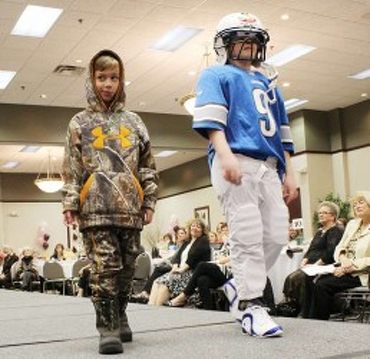 COOL MODELS: Cody and Hayden Brown show off sporty looks from MC Sports in Big Rapids. The St. Peter’s Lutheran School fashion show raised more than $12,000 for the school.