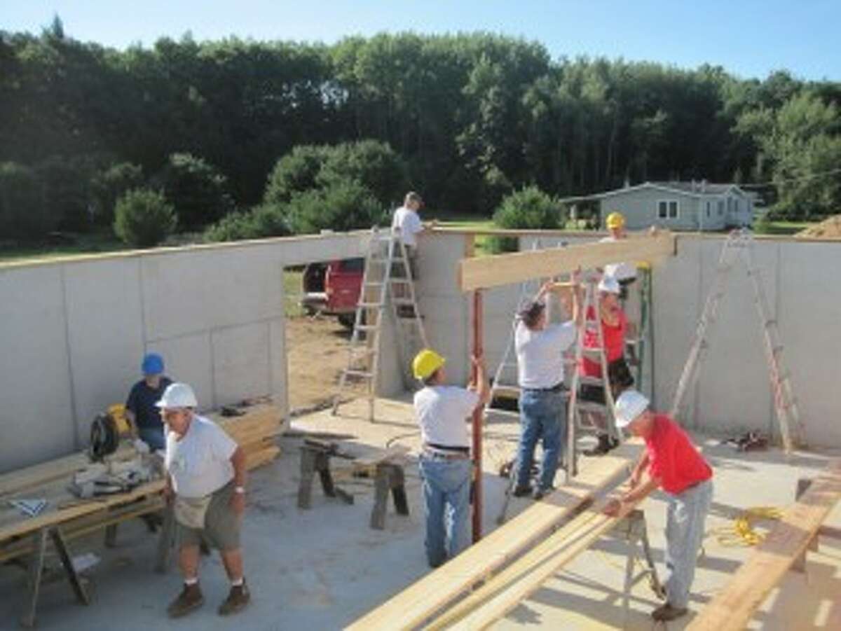 LABOR OF LOVE: A group of volunteers work during the beginning stages of a build. (Courtesy photo)