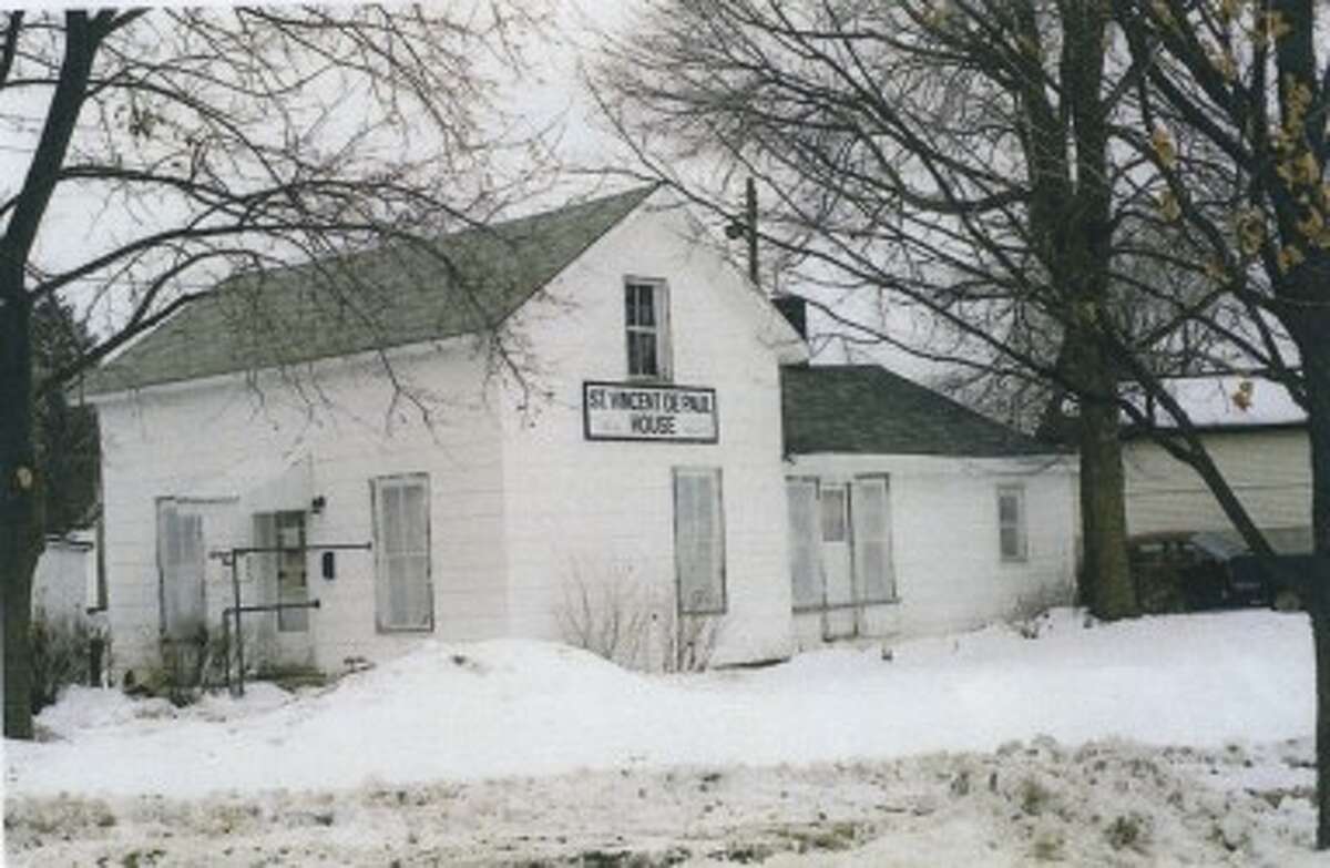THE PAST: A photo from 1989 shows how the old St. Vincent de Paul Store looked. Referred to as the "little house" by volunteers, it was torn down to make room for another building with about twice the space. (Courtesy photo)