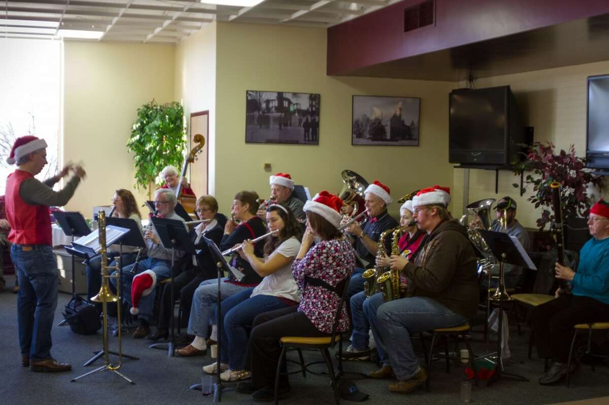 CHRISTMAS CAROLS: Members of Ferris State University’s student and community bands volunteered to play at Ferris Dining Services’ annual Christmas Party on Tuesday for clients in the Hope Network’s MOARC program. (Courtesy photos)