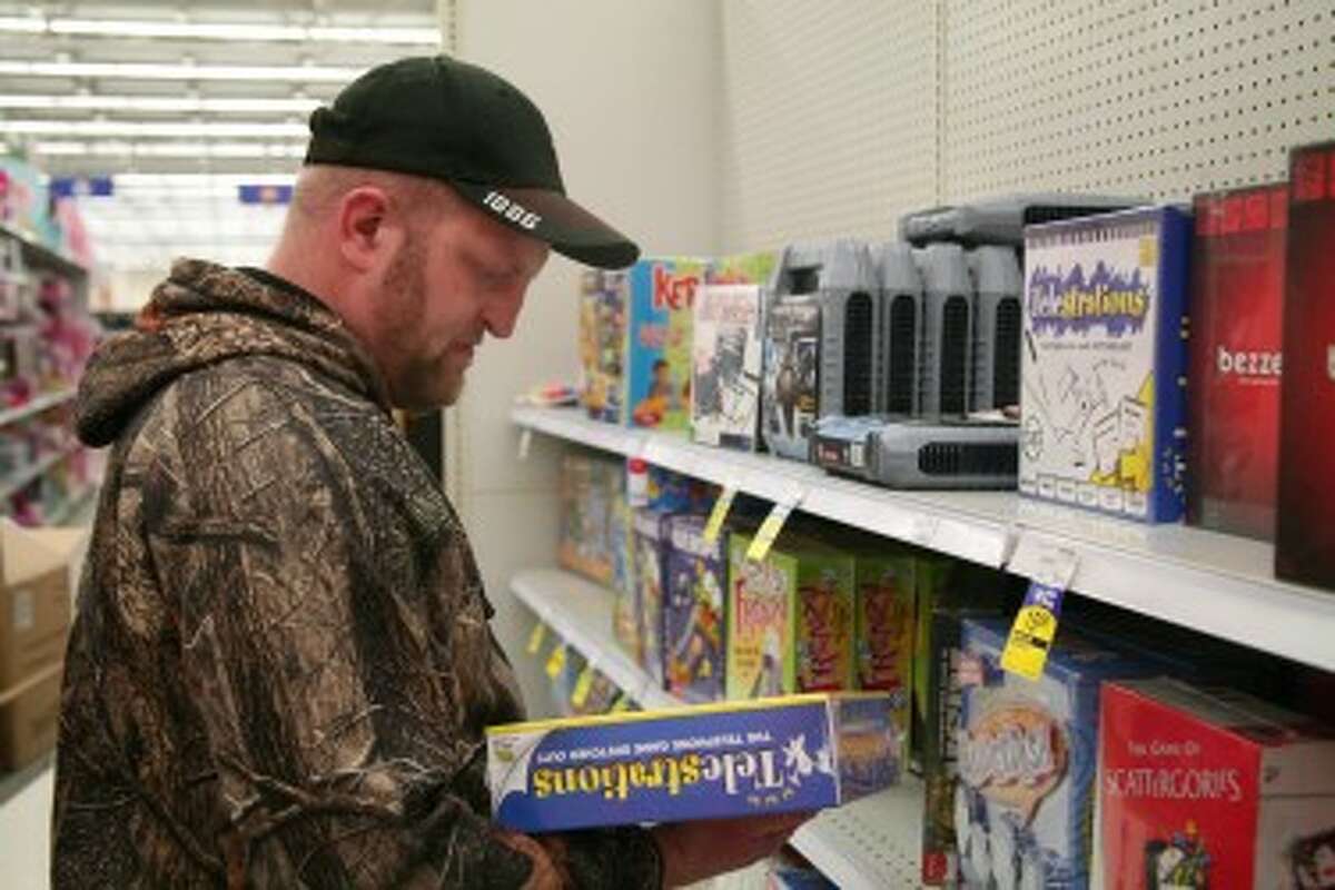 CHRISTMAS SHOPPING: Joe Bandlow shops for board games for his children at Meijer in Big Rapids. He likes to have his Christmas shopping done with time to spare. (Pioneer photos/Jonathan Eppley)