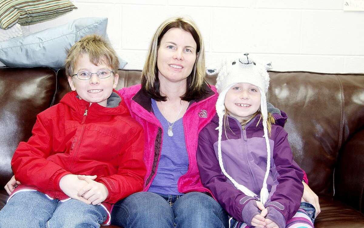 FOR HER CHILDREN: Nikki Jorgensen sits with her children Logan and Laney. Jorgensen began volunteering to lead art projects at Brookside Elementary School after the art program was eliminated because she wanted to her children to experience art at a young age. (Pioneer photos/Lauren Fitch)