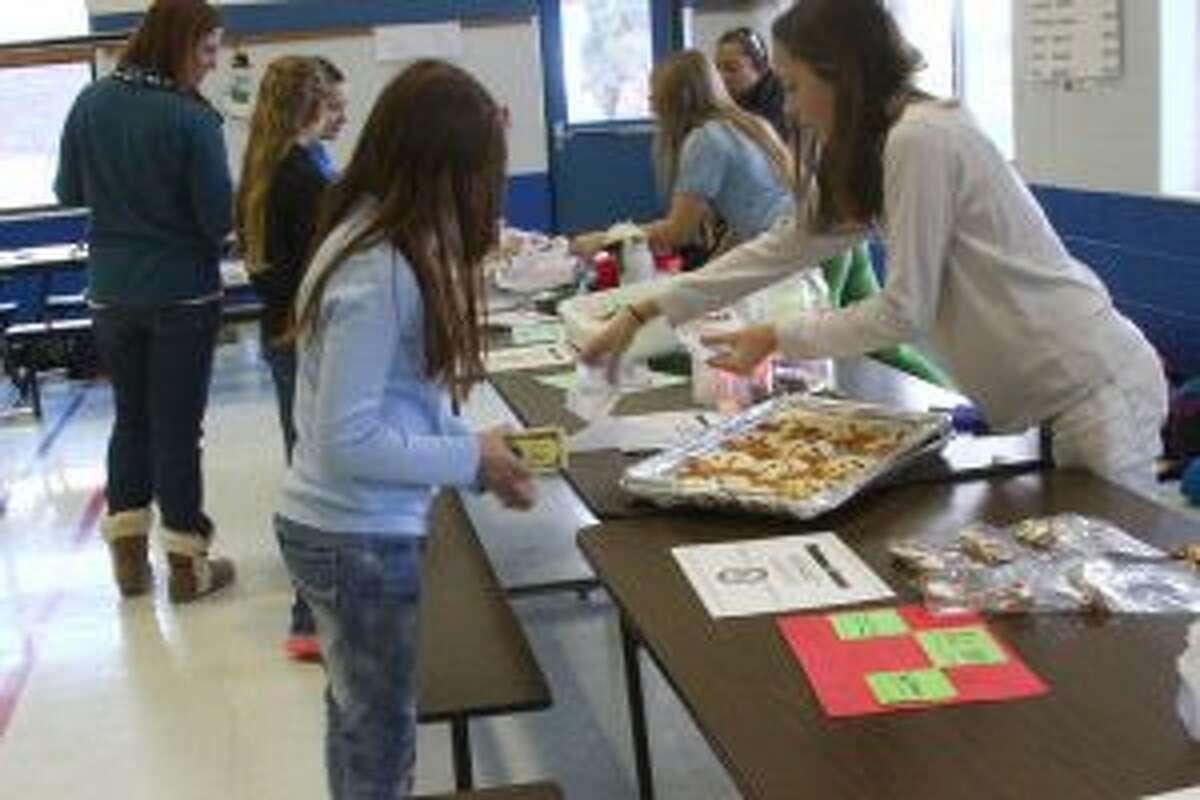 MAKING A SALE: During Market Day, students, parents and staff had a chance to buy crafts or treats made by sixth-graders, including reindeer cookies.