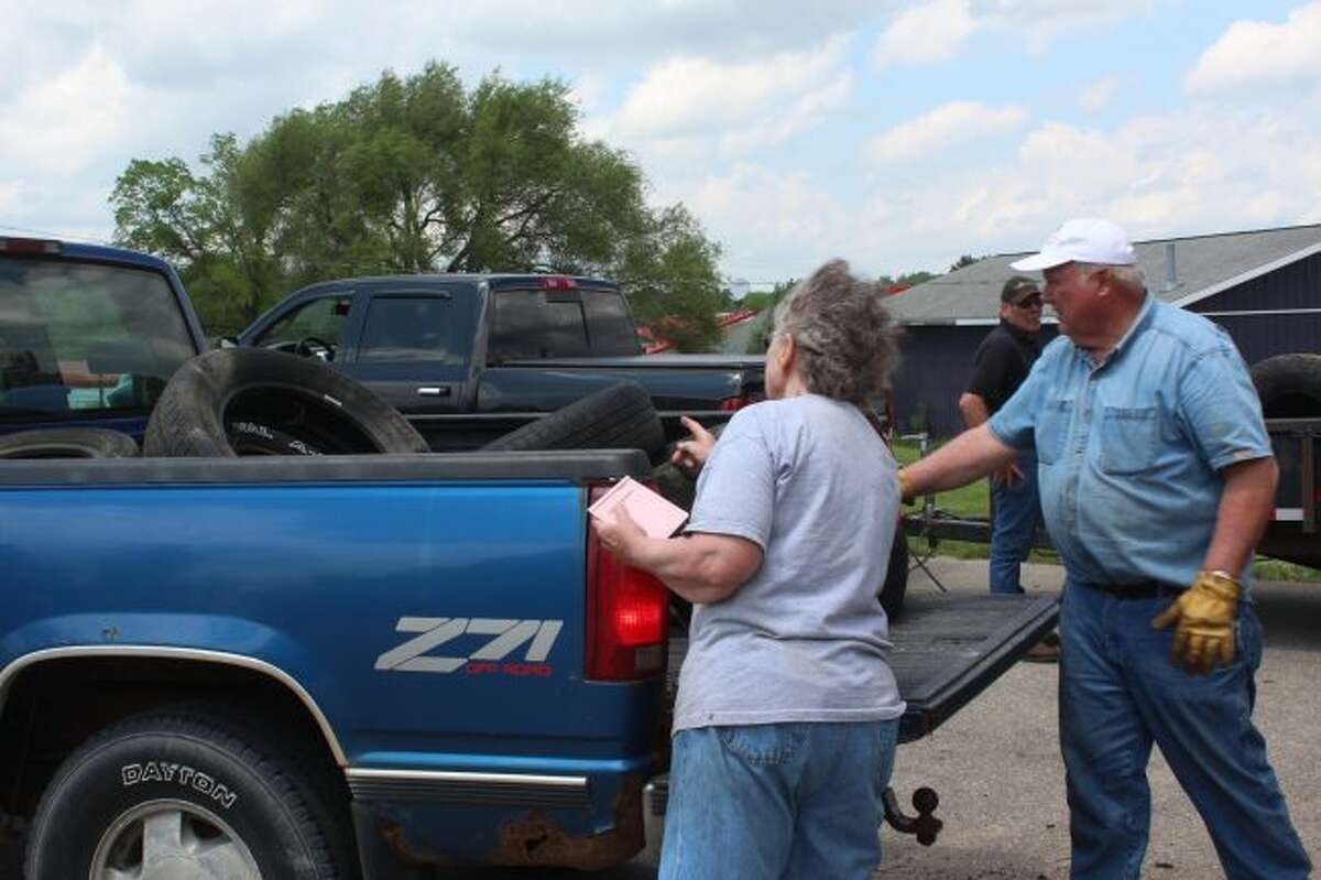 Peggy (left) and Bob (right) Hoard count tires being dropped off Thursday afternoon to the annual scrap tire cleanup at Middle Branch Township Hall. A grant from the Michigan Department of Environmental Quality helps pay for the proper disposal of the scrap tires. (Pioneer photo/Brandon Fountain)