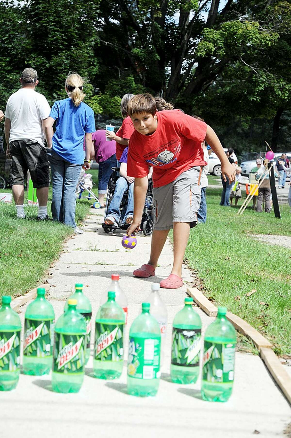 STRIKE!: A child participates in one of several games at the Hersey United Methodist Church on Saturday. In addition to children’s games, the River Town Festival included a flea market, a parade, live music, a pancake eating contest, softball tournament and cookouts. (Pioneer photo/Kyle Leppek)