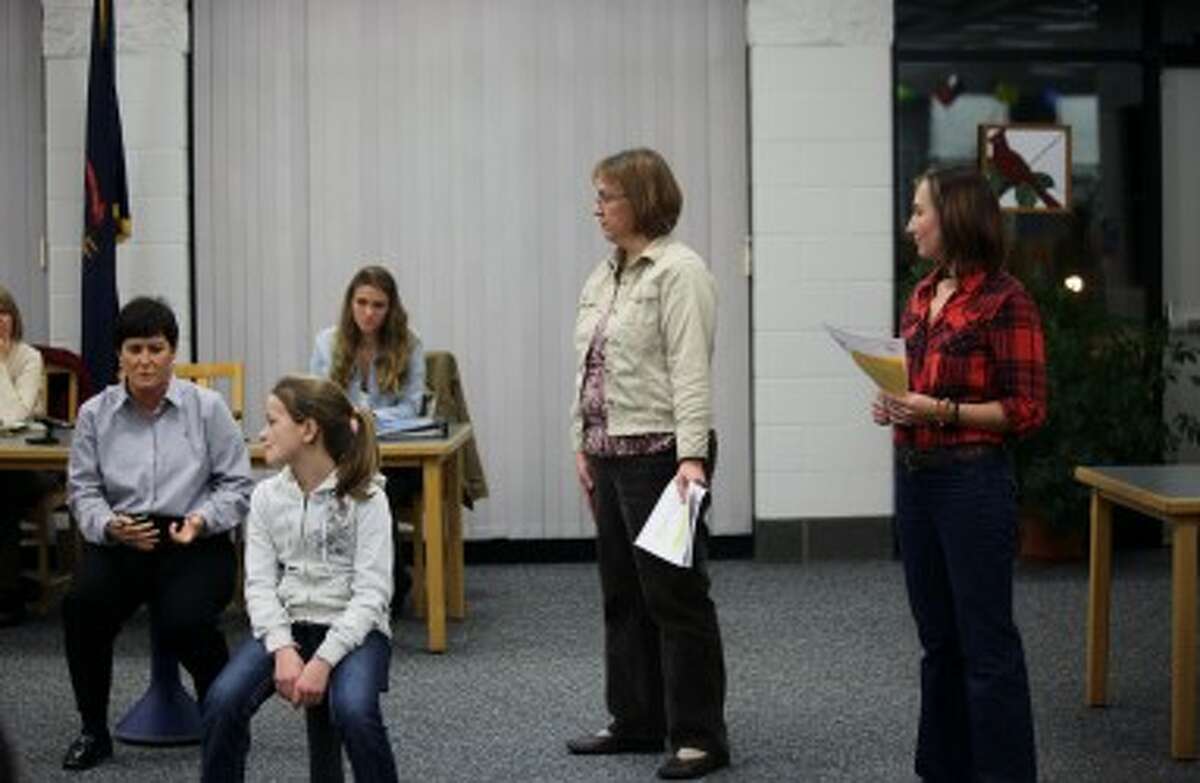 ACTIVE STOOLS: Riverview Elementary School Principal Renee Kent (left) and teachers Courtney Steers (center) and Amber Alger (right) explain the benefits of Hokki stools, which help active students focus during class, at the BRPS board meeting on Monday. Riverview and Brookside will each purchase three Hokki stools with funds from the Big Rapids Student Success Fund. (Pioneer photo/Lauren Fitch)