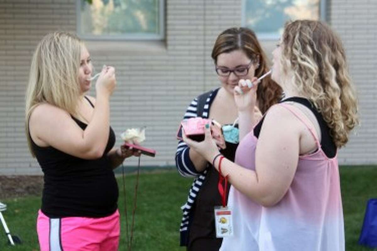 FOUNDERS' DAY: Ferris students Brooke Krozek, Lynnette Pippin and Carly Grace enjoy their ice cream at the Founders' Day celebration on Thursday. The event included games, booths from on-campus groups, dinner and ice cream scooped by community leaders and university administrators.