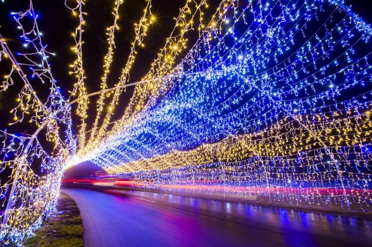 Cars slowly stream through one of the many tunnels of light at the Fifth Third Ballpark Spirit of the Season light display. (Pioneer photo/Justin McKee)