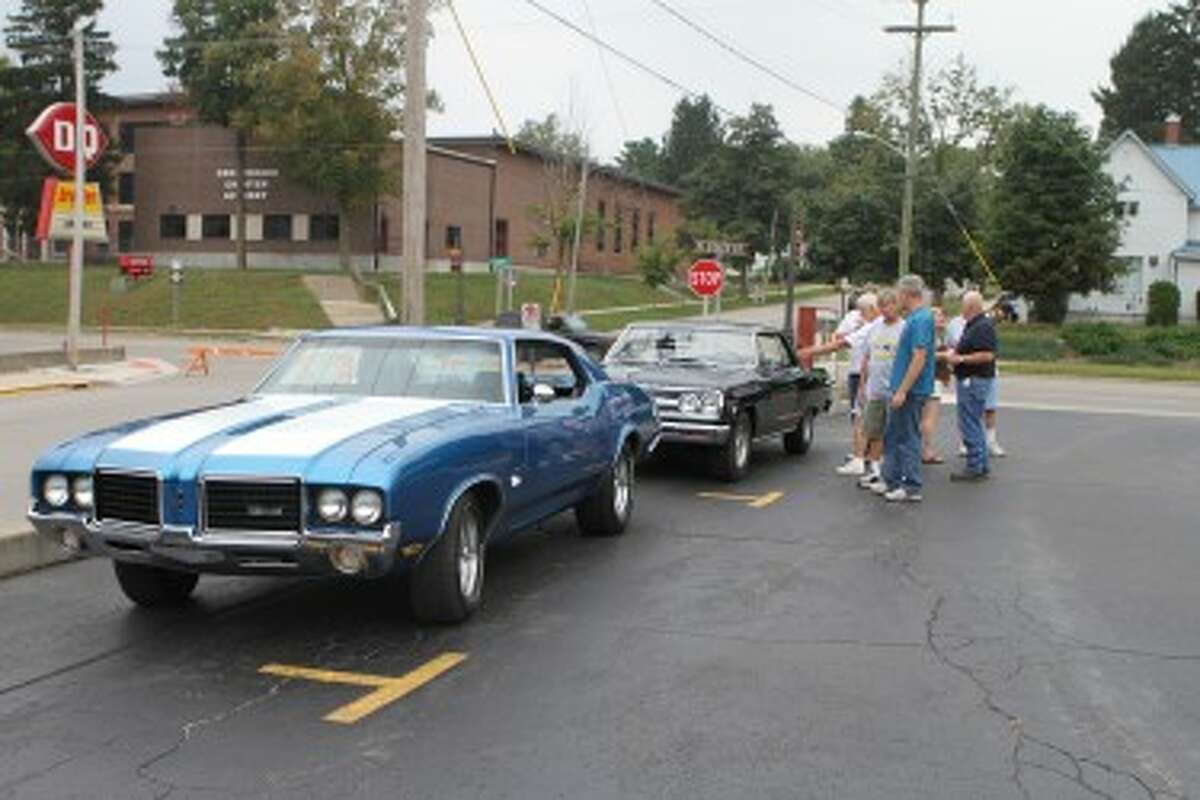 CHECKING IT OUT: New friends and old check out cars during the Car Cruise at A&W on Friday night. The event was a part of the annual Riverdays Festival.