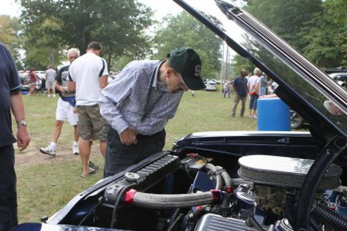 CLASSIC: A man looks at one of the many classic cars during the 10th annual Canadian Lakes Cruisers Club car show.