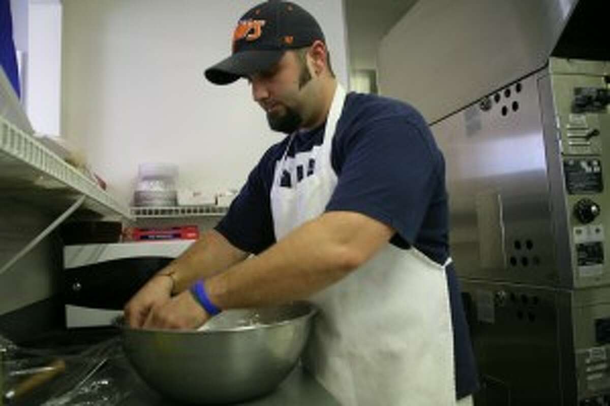 PREPARING: Casey Councilor, co-owner of Pizza in Paris, prepares dough at his business. He said for small businesses to thrive, the community and other businesses need to come together and support each other.