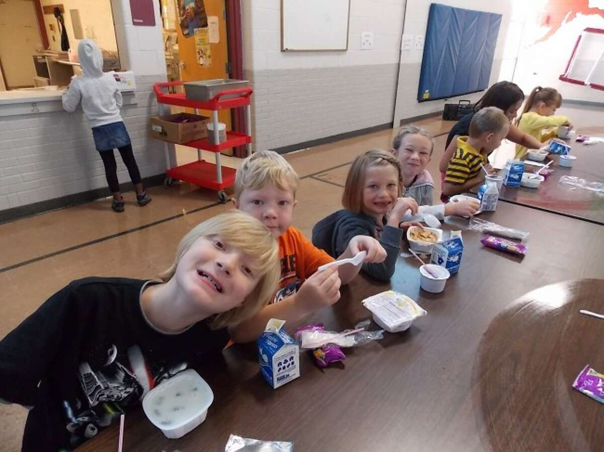 Riverview students eat breakfast at school.