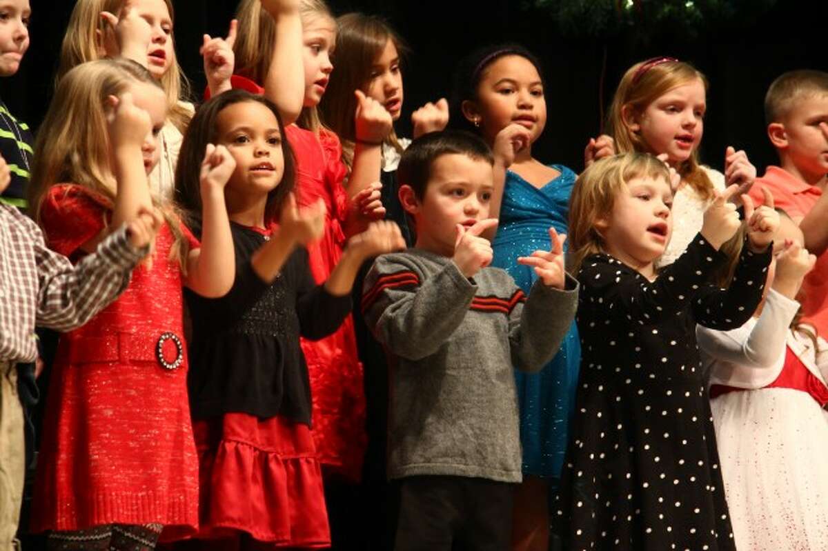 HO HO HO: With family and friends packed into the Mecosta Elementary School gymnasium, kindergartners sing and dance to holiday tunes as part of the school's concert.