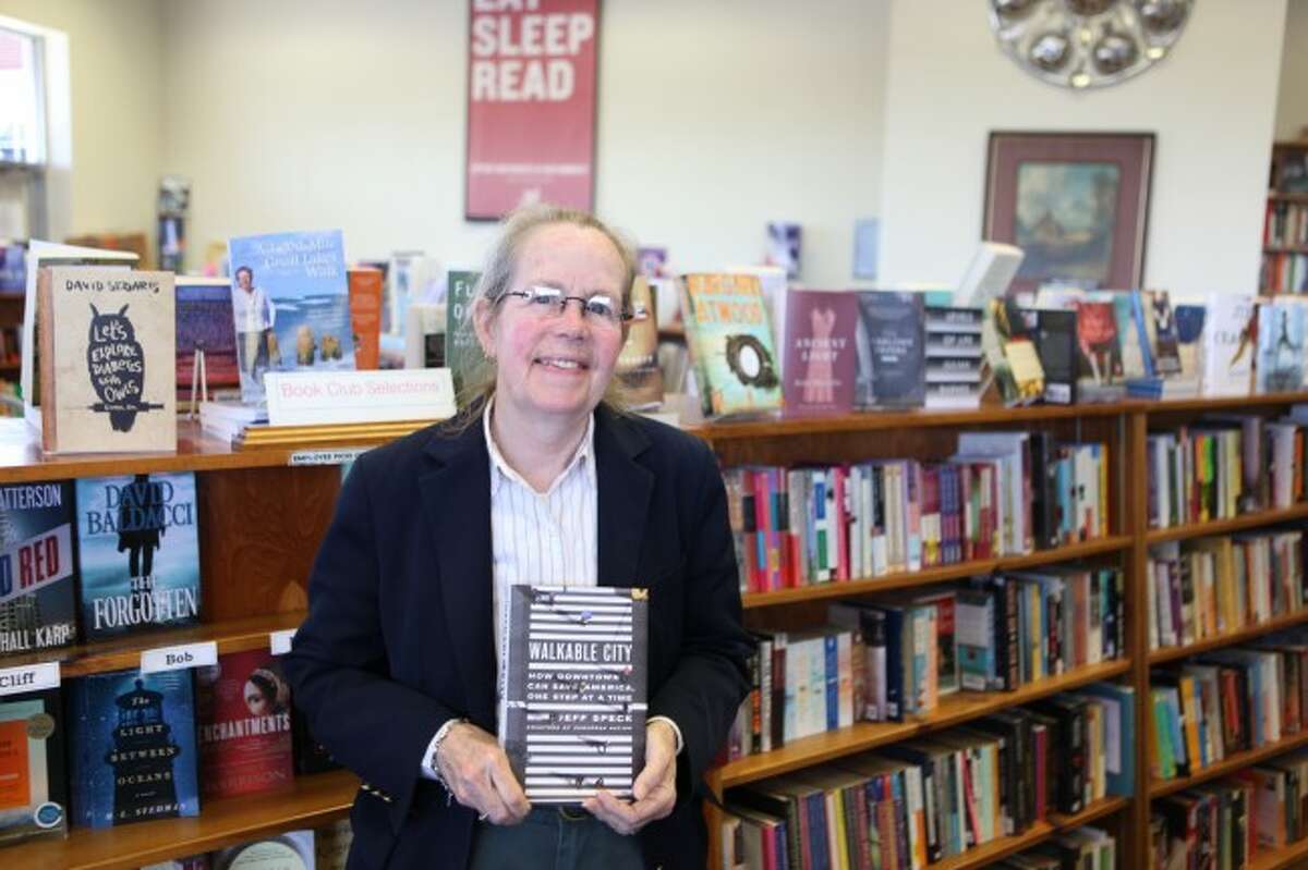DOWNTOWN READING: Lynn Anderson holds "Walkable City: How Downtown Can Save America, One Step at a Time," by Jeff Speck.