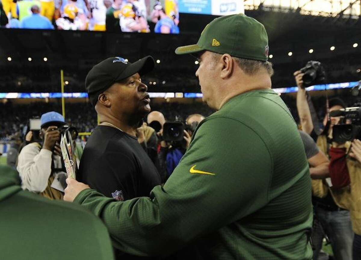 Detroit Lions head coach Jim Caldwell, left, meets with Green Bay Packers head coach Mike McCarthy after an NFL football game, Sunday, Dec. 31, 2017, in Detroit. (AP Photo/Jose Juarez)