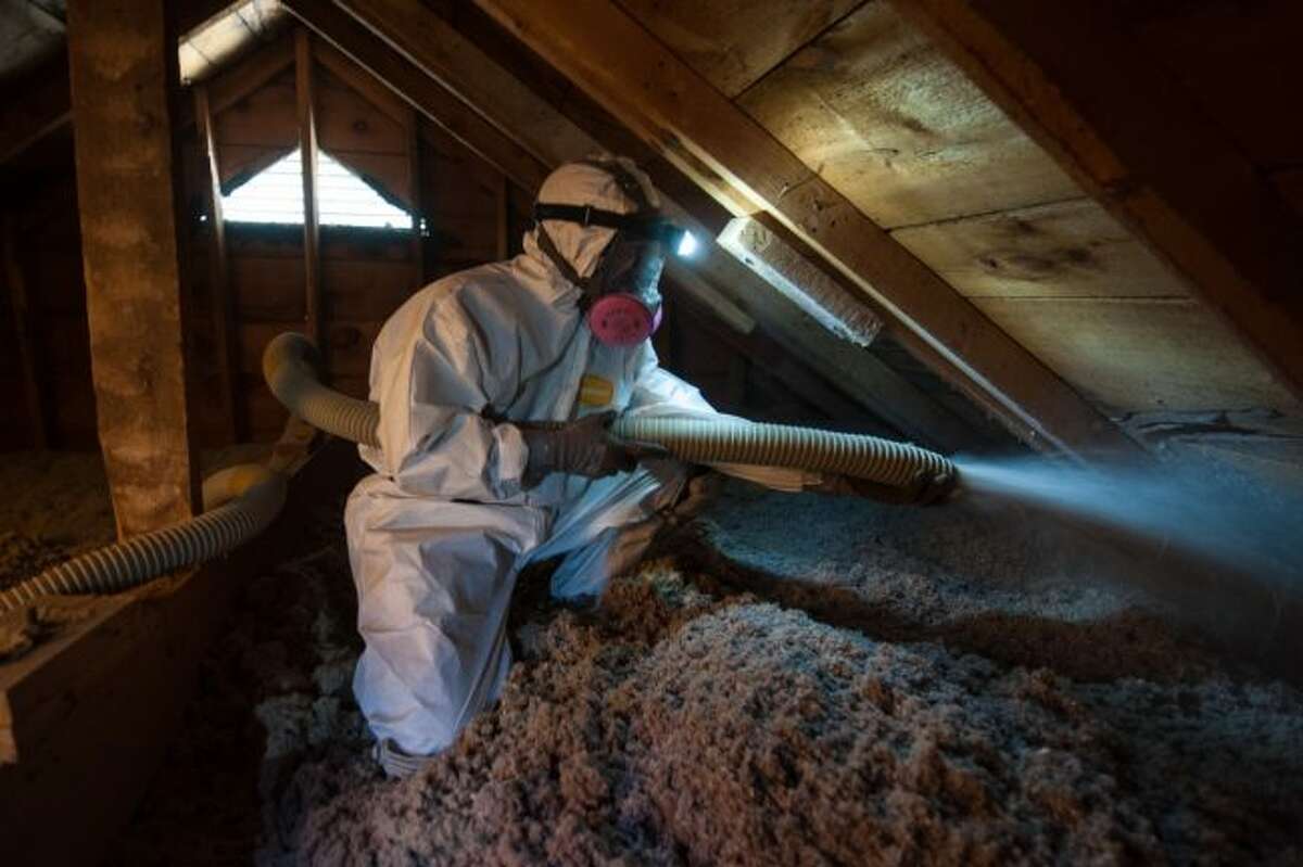A professional spays an attic with insulation. Adding insulation is one way to weatherize a home and reduce energy costs, according to the U.S. Department of Energy. (Courtesy photos)