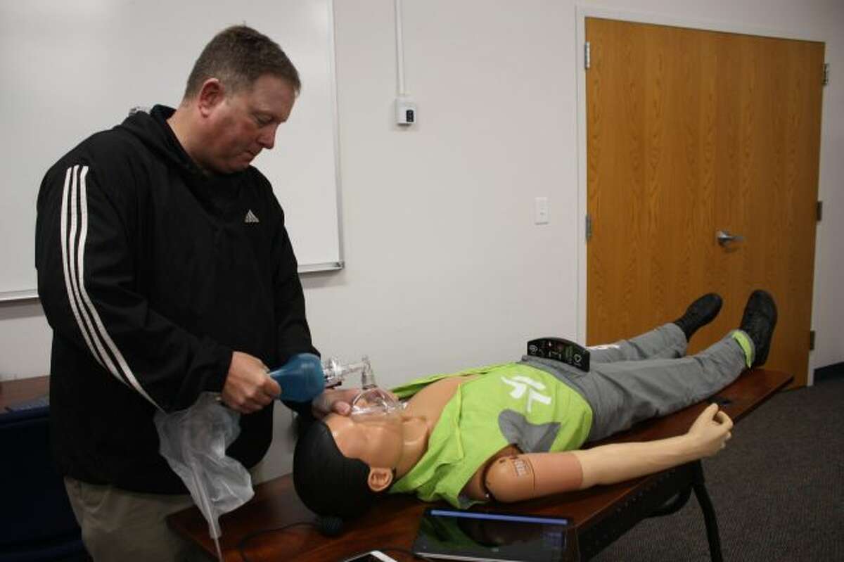 Mecosta EMS Director Tim Ladd intubates "Andy," the unit's new manikin. (Pioneer photo/Tim Rath)