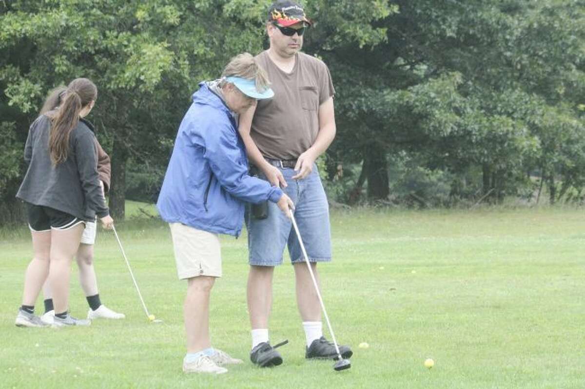 Spring Valley volunteers work with blind golfers at the driving range on Thursday. (Pioneer file photo)