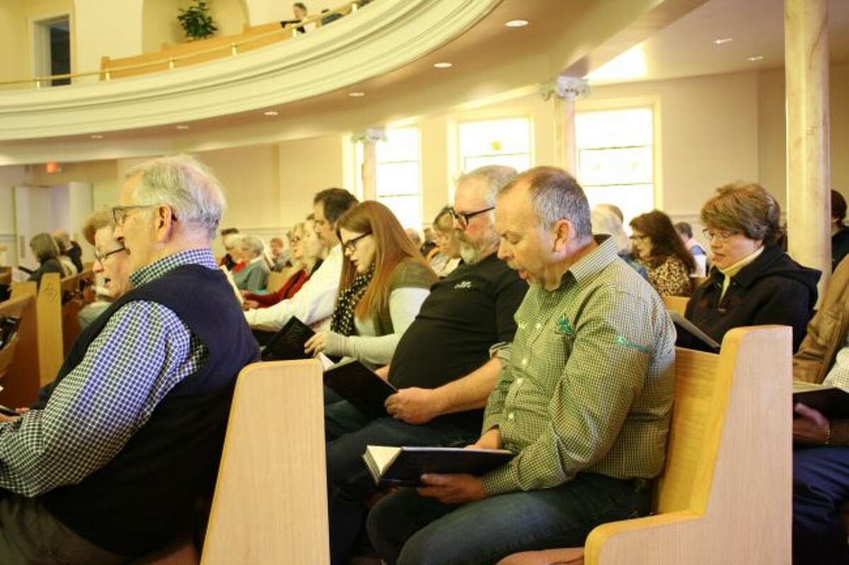 Local residents sing a hymn together during the community Good Friday service at Big Rapids First United Methodist Church. The service was a joint worship, led by pastors of several area churches. (Pioneer photo/Candy Allan)
