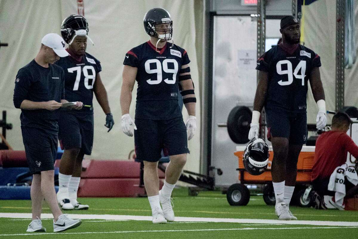 Houston Texans nose tackle Javier Edwards (78), defensive end J.J. Watt (99) and defensive end Charles Omenihu (94) walk up the field to the next drill during training camp at the Methodist Training Center on Friday, July 26, 2019, in Houston.