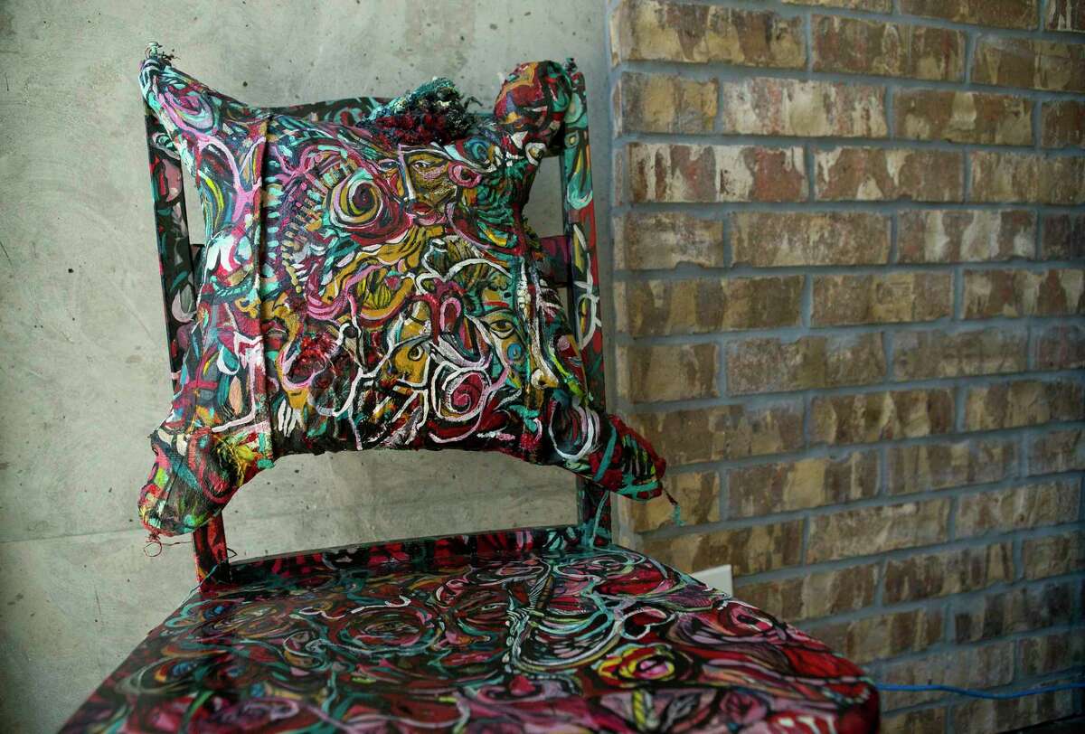 A piece by artist Gerard Caliste sits inside a common gallery space inside the Mid Main Lofts in Houston, Thursday, July 25, 2019. Lane and Bob Schultz have worked to fill much of the common areas along Main Street in that section of midtown with public art form murals to window displays in currently vacant buildings.