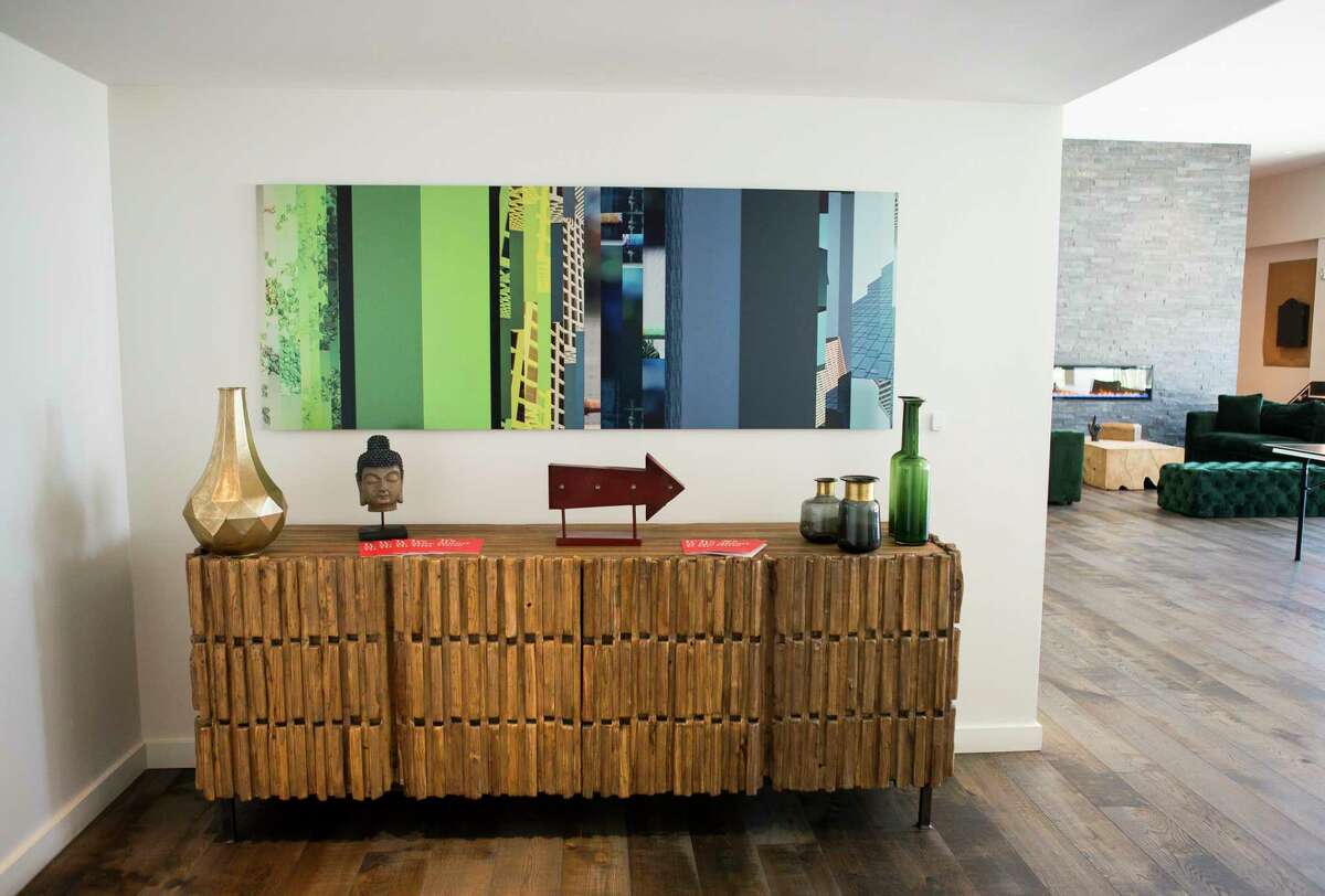 A photo-based conceptual art piece by David A. Brown hangs in a common area inside the Mid Main Lofts in Houston, Thursday, July 25, 2019. Lane and Bob Schultz have worked to fill much of the common areas along Main Street in that section of midtown with public art form murals to window displays in currently vacant buildings.