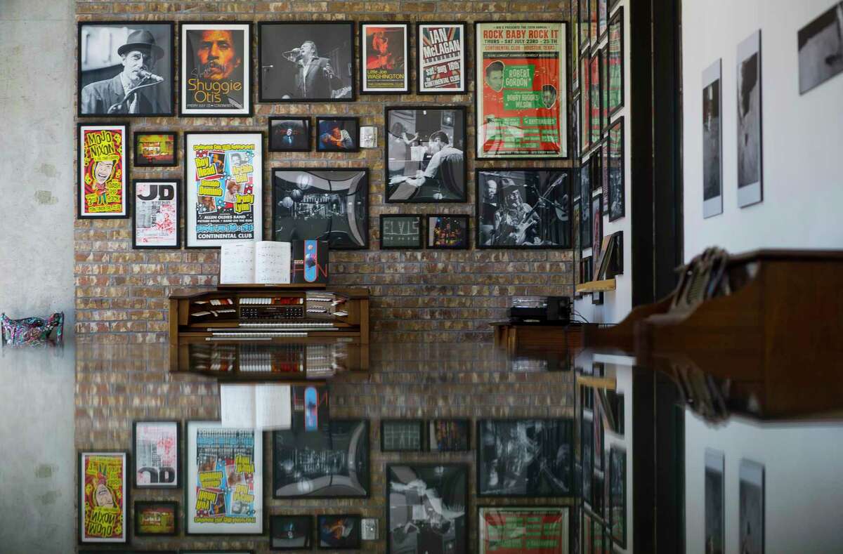 Concert posters and photographs from photographer Jay Lee fill the walls on a common area that serves as a gallery inside the Mid Main Lofts in Houston, Thursday, July 25, 2019.