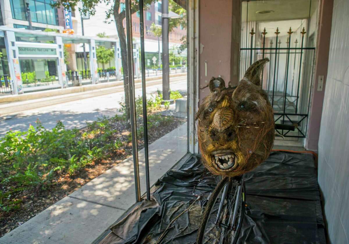 A piece by Scrapdaddy, Mark Bradford, is displayed in a window across Main Street from the Mid Main Lofts in Houston, Thursday, July 25, 2019. Lane and Bob Schultz have worked to fill much of the common areas along Main Street in that section of midtown with public art form murals to window displays in currently vacant buildings.