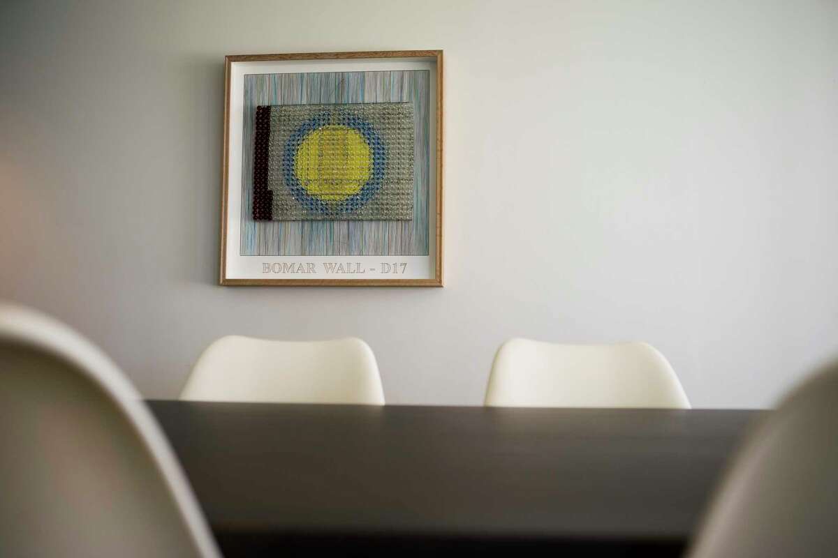 A piece by artist Selven Jarmon hangs inside a common room in the Mid Main Lofts in Houston, Thursday, July 25, 2019. Lane and Bob Schultz have worked to fill much of the common areas along Main Street in that section of midtown with public art form murals to window displays in currently vacant buildings.