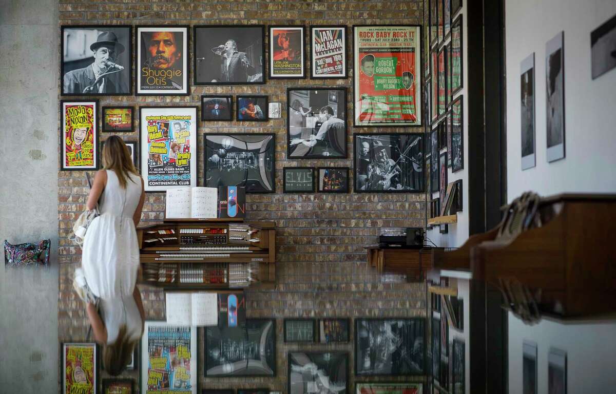 Concert posters and photographs from photographer Jay Lee fill the walls on a common area that serves as a gallery inside the Mid Main Lofts in Houston, Thursday, July 25, 2019.