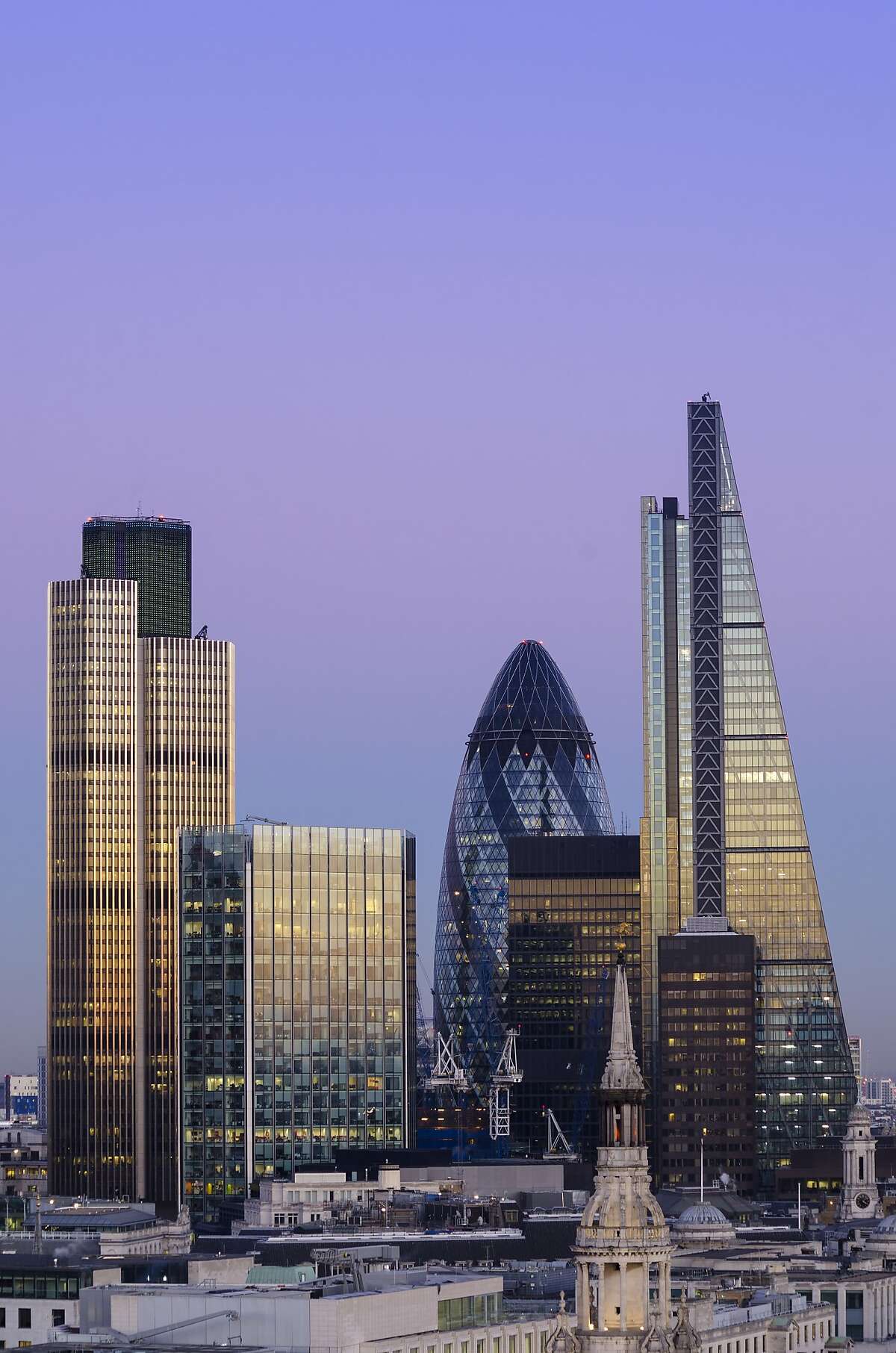 Elevated view of The City of London at dusk. The City is London's traditional financial and global business district. The distinctive 'Gherkin' skyscraper, Tower 42 and the recently completed 122 Leadenhall Street feature on the constantly changing skyline.