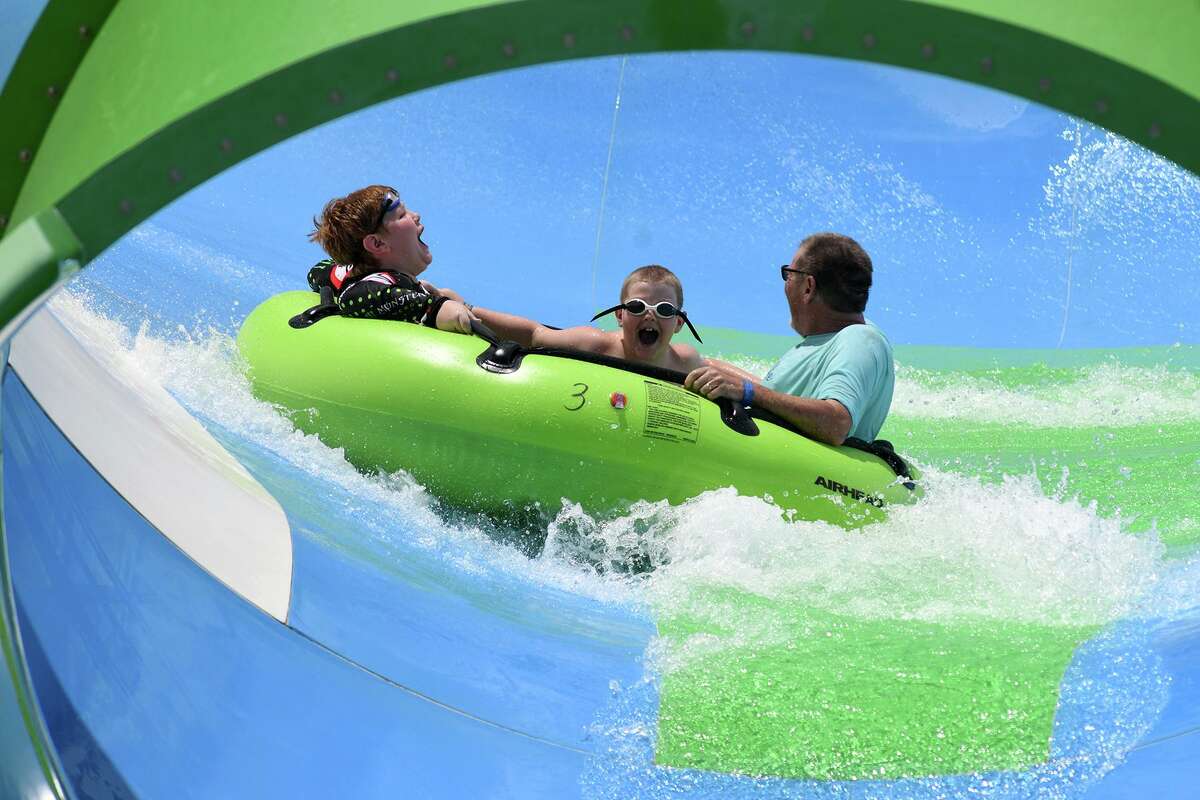 A trio of park goers try on one of the new slides for size at Big Rivers Water Park on July 10, 2019.