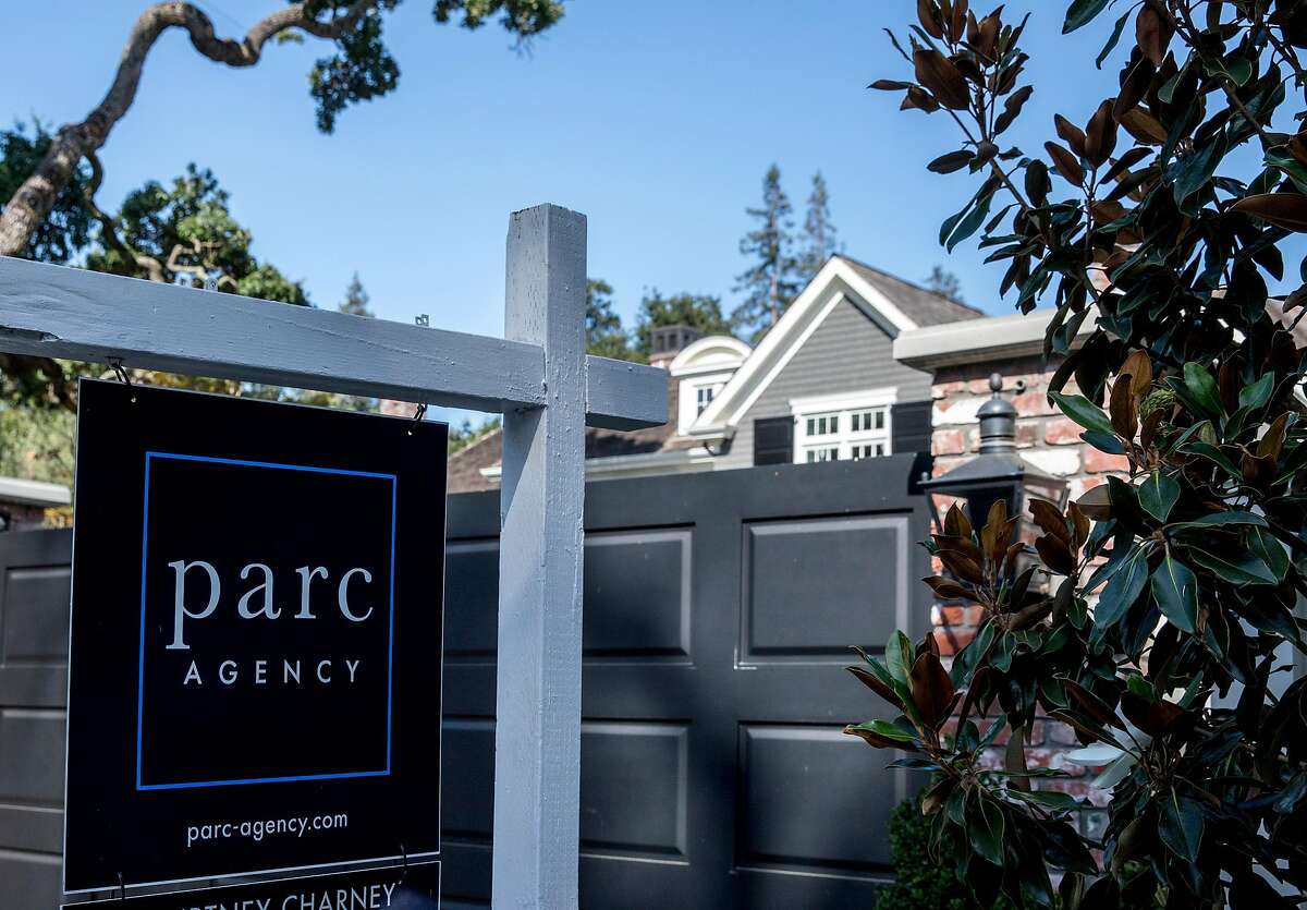 A home at 190 Almendral Avenue is seen with a For Sale sign posted outside the front gates in Atherton, Calif. Thursday, July 25, 2019.