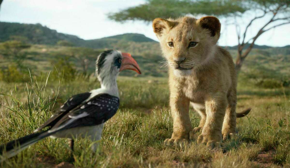 This image released by Disney shows characters, from left, Zazu, voiced by John Oliver, and young Simba, voiced by JD McCrary, in a scene from