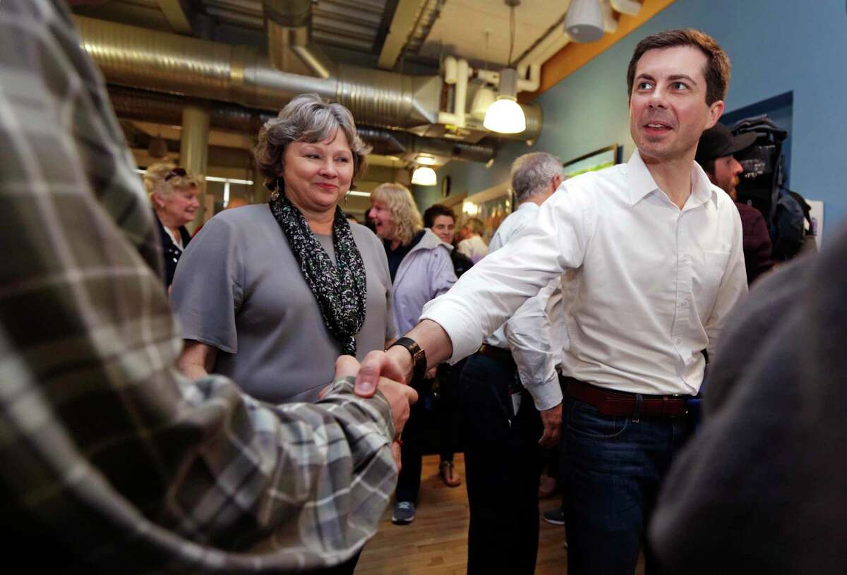 Democratic presidential candidate South Bend Mayor Pete Buttigieg shakes hands with an employee during a campaign stop at a dairy company in Londonderry, N.H., Friday, April 19, 2019. (AP Photo/Charles Krupa)