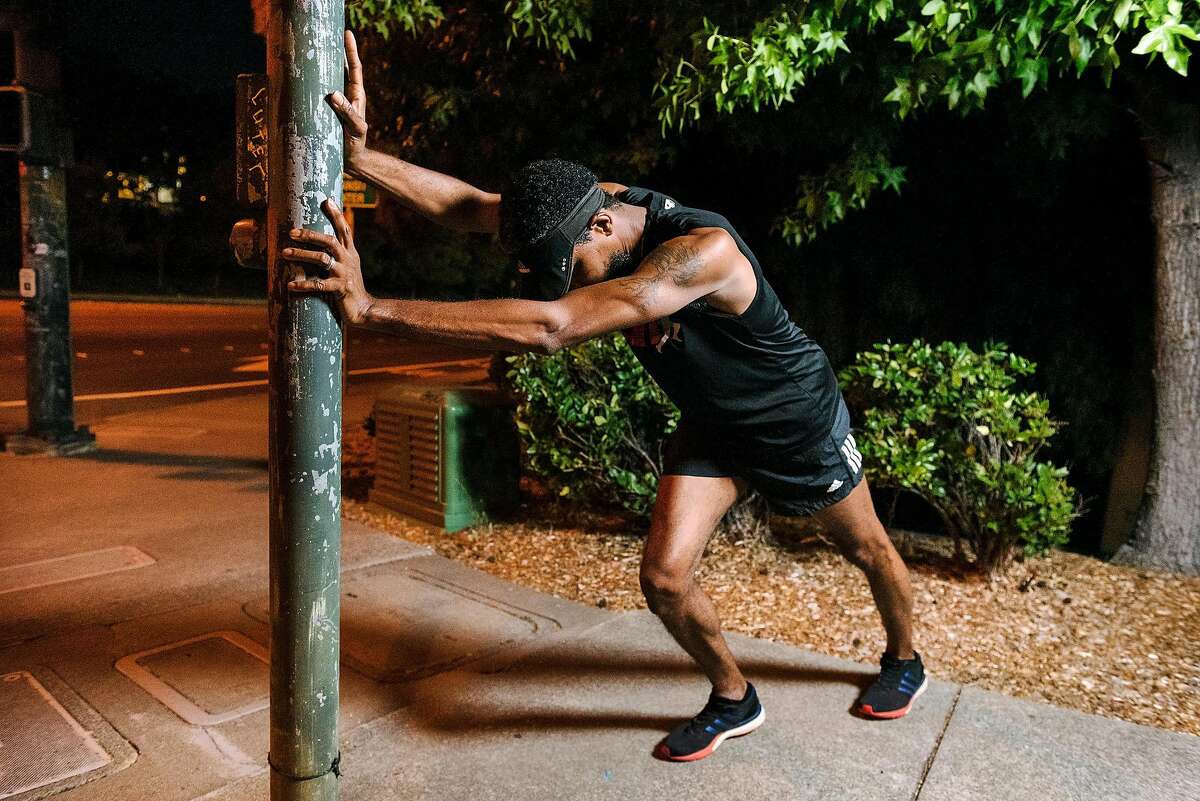 Kyrah Ayers stretches before taking an early morning run while training to run the half-marathon during the upcoming San Francisco Marathon, in Hercules, Calif., on July 25th, 2019. Kyrah is the president of the Bay Area chapter of Black Men Run, a group that promotes overall health and fitness, and focused on running.