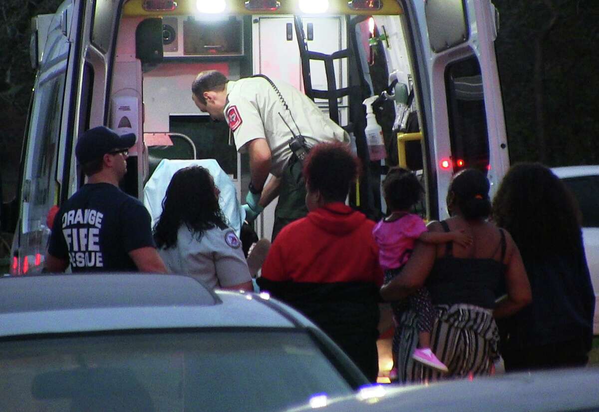 Emergency officials tend to a gunshot child in the back of an ambulance in Orange late Monday evening. Photo provided by Eric Williams