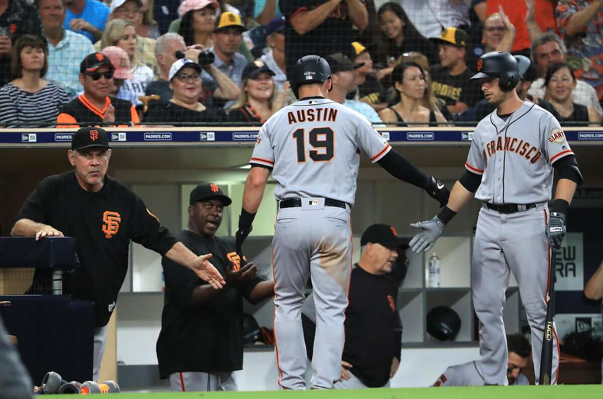 SAN DIEGO, CALIFORNIA - JULY 26: Tyler Austin #19 o is congratulated at the dugout by manager Bruce Bochy of the San Francisco Giants after scoring on an RBI double hit by Donovan Solano #7 of the San Francisco Giants during the third inning of a game against the San Diego Padresat PETCO Park on July 26, 2019 in San Diego, California. (Photo by Sean M. Haffey/Getty Images)