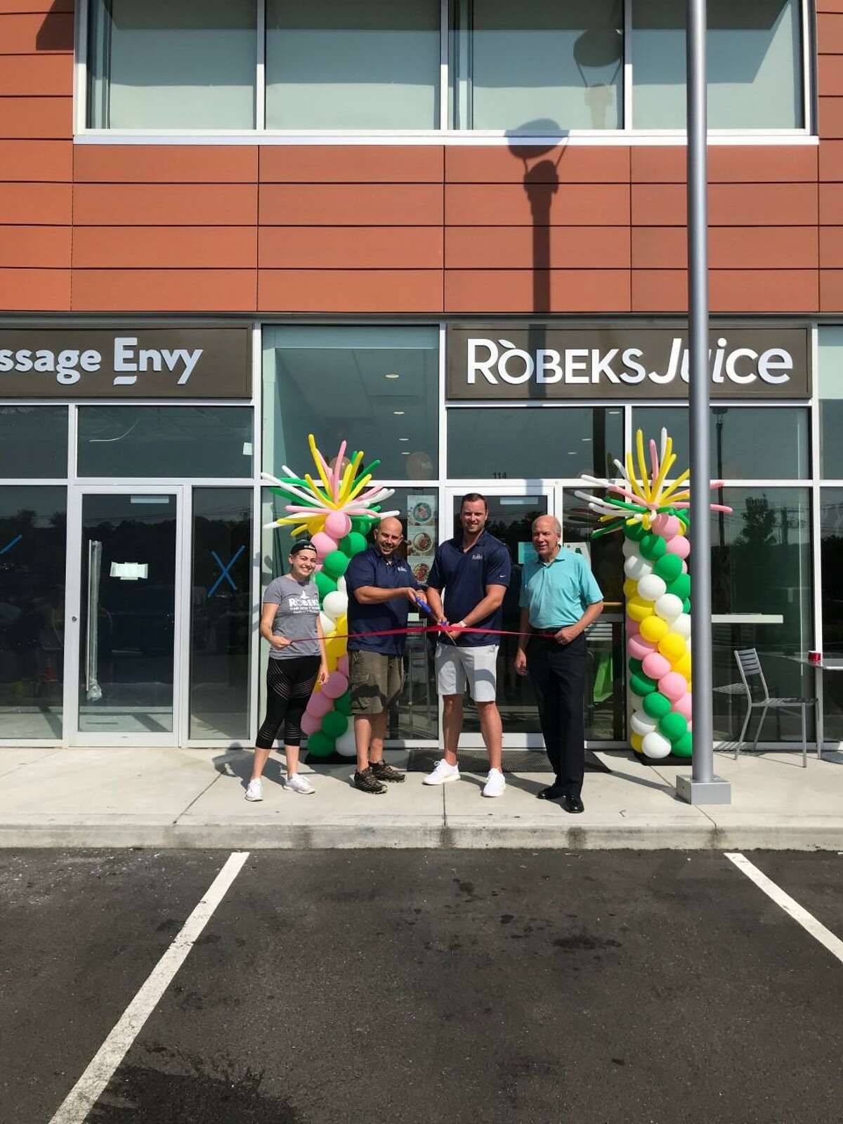 Valley Chamber of Commerce President Bill Purcell, far right, joined Robeks owners Patrik Kovac and Mark Henriques for the business’ grand opening Saturday, July 20.