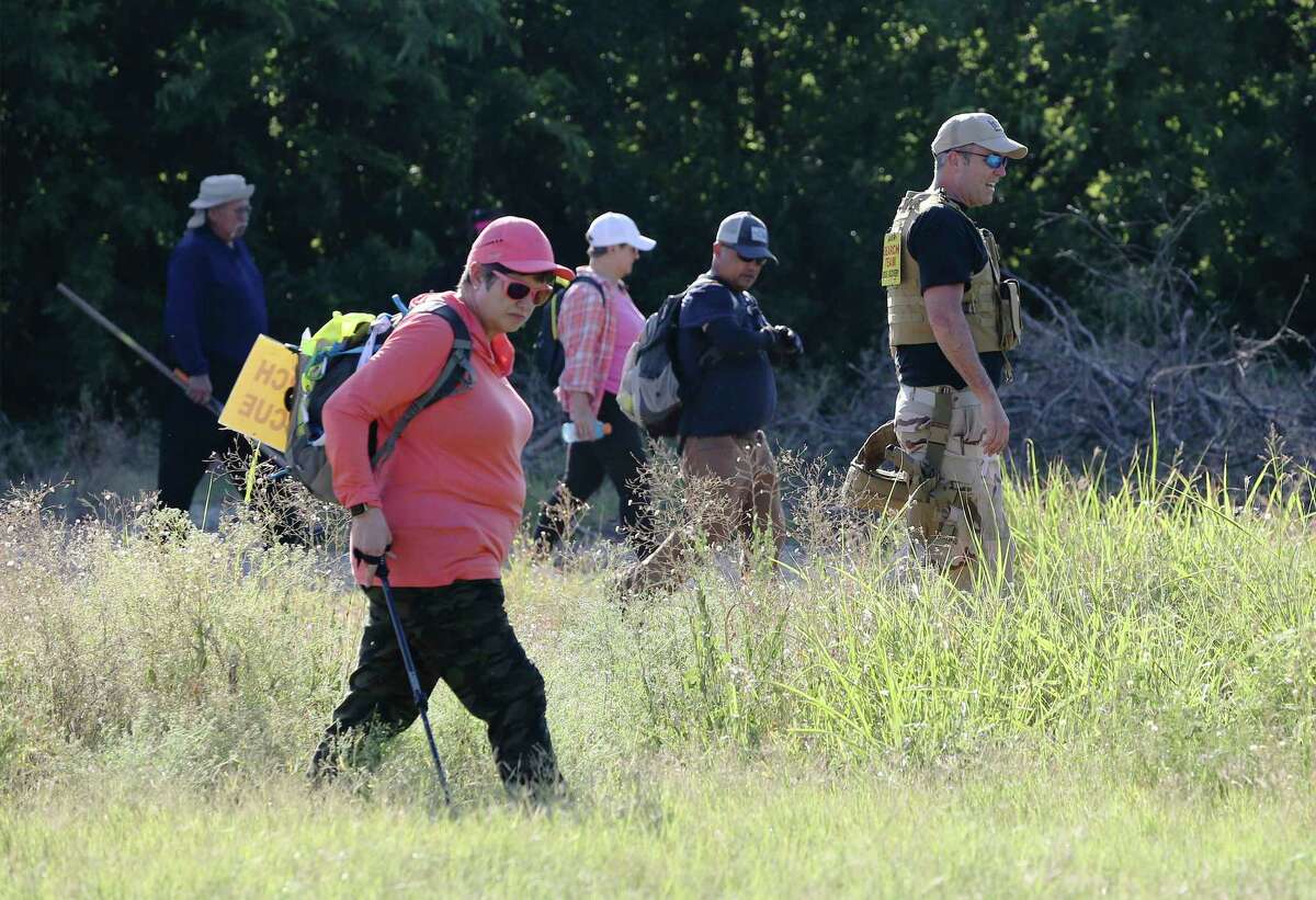 A line of searchers with Search & Support San Antonio comb a field for Cecilia Huerta Gallegos on Saturday, July 27, 2019. Gallegos, 30, was last seen in the 5600 block of Southwick Street on July 8, according to the San Antonio Police Department. On Saturday, about a dozen searchers including Gallegos' sister Mireya Lopez of Houston went to six different locations in an effort to draw to a close the disappearance of the mother of four children. (Kin Man Hui/San Antonio Express-News)